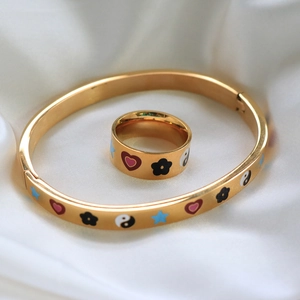 Gold-plated jewelry set with heart star and Yin Yang symbols on silk background