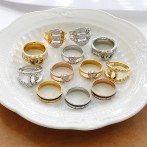 Detailed view of assorted luxury Roman numeral rings and heart motifs in gold and silver