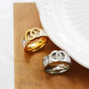 Detail of interlocking Roman numeral rings with micro-pave crystals in gold and silver