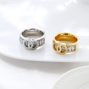 Detail of interlocking Roman numeral rings with square cubic zirconia in gold and silver