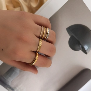 Minimalist stackable gold and silver rings set with pavé stones and twisted designs
