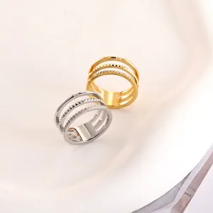 Detailed macro view of triple-layered geometric rings in gold and silver finish
