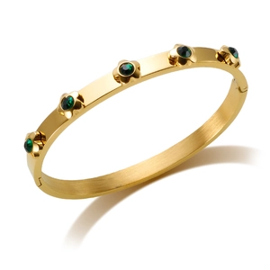 Elegant gold stainless steel bangle featuring five-petal flowers and green gemstone inlays