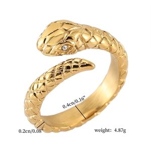 Macro detail of gold plated snake ring with sparkling zircon stone and scaled texture
