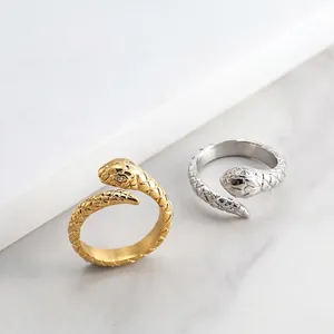 Detailed view of the winding snake ring with scale texture and rhinestone eye embellishments