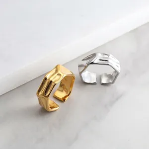 Macro shot of liquid metal texture on irregular adjustable gold and silver rings