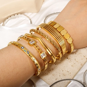Gold stainless steel stackable bangle set with emerald zircon and evil eye charm