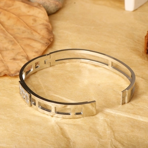 Silver hollow titanium steel bracelet featuring rectangular zircon stones on a leaf background