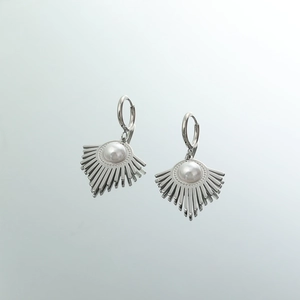 Macro view of silver geometric U-shaped earrings with fan-shaped metal and white pearl