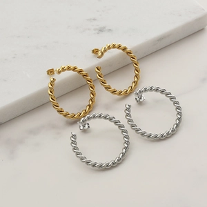 Classic braided hoop earrings in gold and silver finish with minimalist twisted design