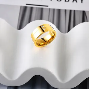 Detail of gold pear-shaped zircon ring on a white decorative wave plaster base