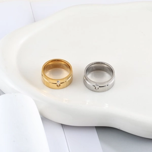 Detailed close-up of gold and silver stainless steel rings with a single inset crystal