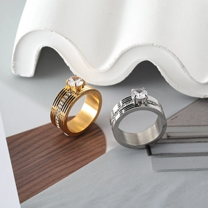 Macro shot of gold and silver stainless steel rings with round center crystal stone