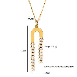 Detailed view of U-shaped gold necklace pendant with dimensions 5.7cm and zircon inlay