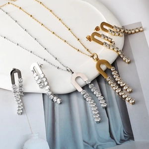 Close-up of polished horseshoe jewelry set with 4A cubic zirconia on ceramic tray