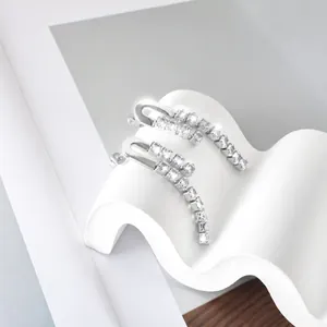 Detailed view of silver stainless steel fringe earrings with cubic zirconia stones