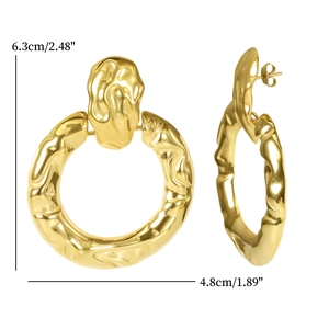 Detail of gold oversized door knocker earrings featuring irregular lava texture and 6.3cm height