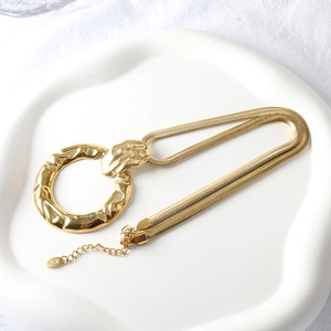 Gold two-tone flat snake chain necklace with hammered texture circular pendant for women