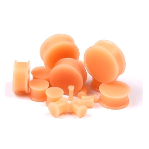 Flesh-colored silicone ear gauge set with multiple sizes in double flare design