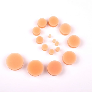 Detailed set of skin-tone silicone ear gauges and tunnels in various sizes for stretching