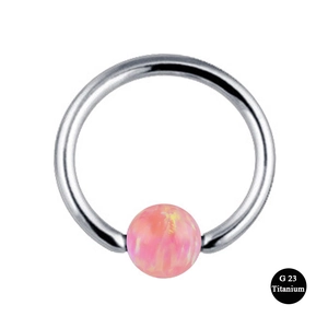 Detail of G23 titanium captive bead ring with shimmering pink opal stone centerpiece