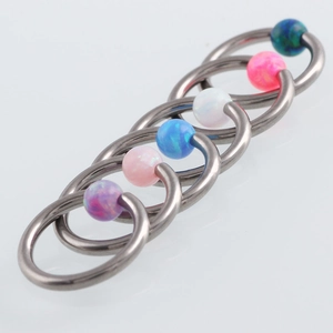 Close-up of captive bead rings with colorful opal stones for body piercing jewelry