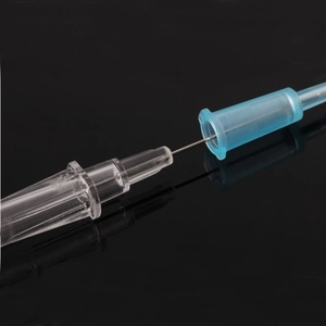 Macro view of medical stainless steel piercing needle with blue Luer lock connector