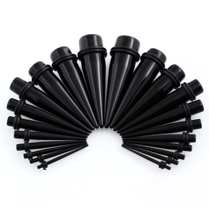 Black acrylic ear stretching taper kit with O-rings in multiple sizes on white background