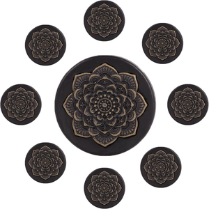 Retro wooden ear gauge set with golden mandala flower relief on black background
