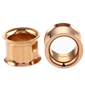 Macro shot of rose gold double flared stainless steel ear gauges with polished finish