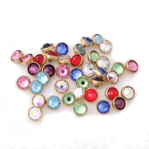 Macro detail of G23 titanium dermal anchor tops with colorful rhinestones and gold base