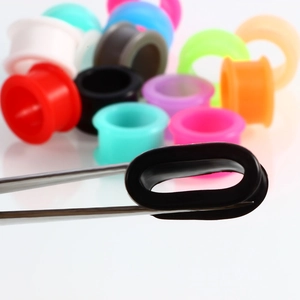Flexible silicone ear gauges set in multiple colors showing high elasticity and soft texture