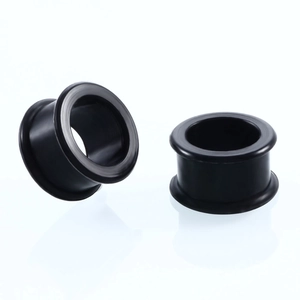 Close-up of black matte silicone ear flesh tunnels showing flared edges for body piercing
