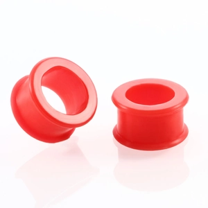 Macro view of double flare red silicone ear tunnel expanders for body piercing jewelry