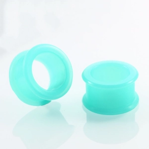 Close-up of a pair of flexible tiffany blue silicone ear tunnels with soft reflections