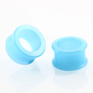 Macro detail of sky blue soft silicone double-flared ear tunnels body piercing jewelry