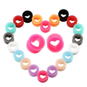 Macro shot of colorful heart-shaped silicone ear gauges for body piercing jewelry