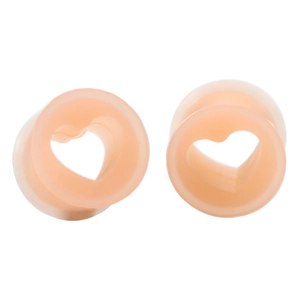 Detail of flesh-colored heart-shaped silicone ear tunnels with hollow design for body piercing