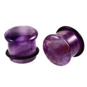 Detailed view of purple natural stone ear plugs with black rubber O-rings on white background