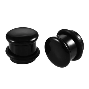 Close-up of polished black natural stone mushroom ear plugs with high gloss finish