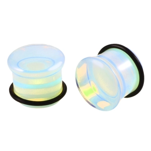 Macro detail of iridescent opal stone ear plugs with black O-ring secure fasteners