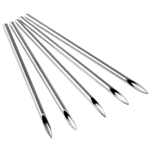 Macro view of five medical grade stainless steel hollow piercing needles with sharp bevel tips