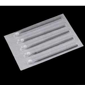 Close-up of 5 disposable sterile body piercing needles with protective caps and steel tips