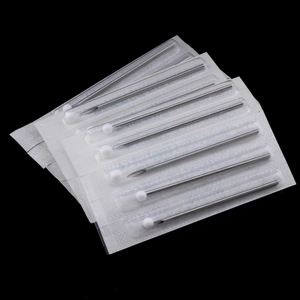 Macro shot of sterile single-use stainless steel piercing needles with protective caps