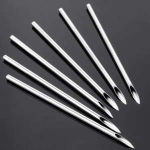 Macro shot of 6 sharp stainless steel body piercing needles with polished beveled tips