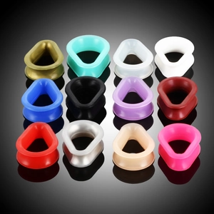 Teardrop silicone ear gauge set in 12 colors shown on a black reflective surface