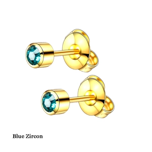 Clous d'oreilles dorés avec zircons bleus facettés et sertissage clos élégant