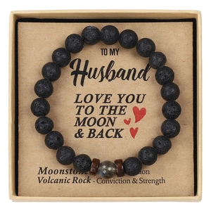 Close-up of black volcanic rock bead bracelet with moonstone in a kraft gift box