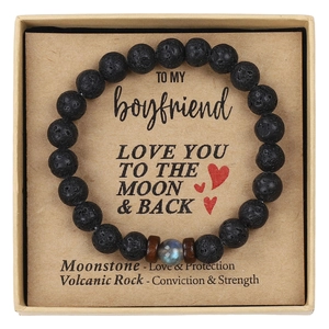 Close-up of volcanic rock and moonstone beads on a gift card for son