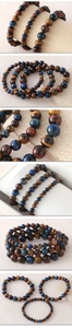 Detailed close-up of tiger eye stone beads in blue brown and red on elastic cord